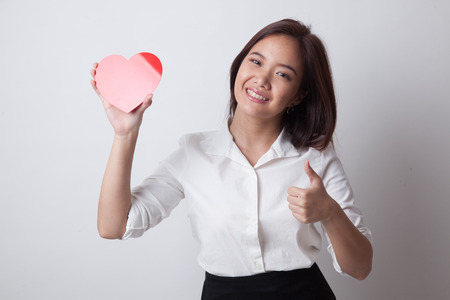 Asian woman thumbs up with red heart on white backgroundの写真素材