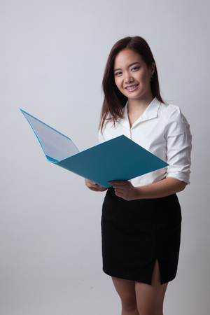 Young Asian woman with folder on white backgroundの写真素材
