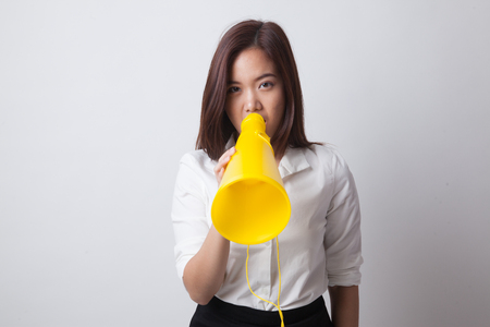 Beautiful young Asian woman announce with megaphone on white backgroundの写真素材