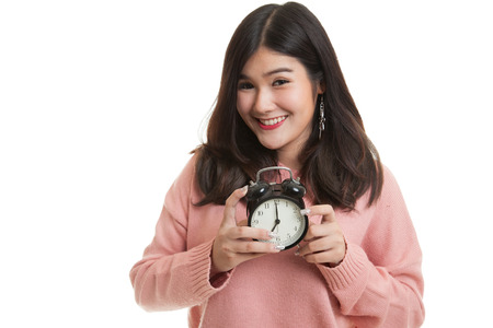 Young Asian woman smile with a clock isolated on white background
