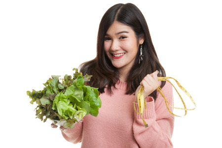 Healthy  Asian woman with measuring tape and salad isolated on white backgroundの写真素材