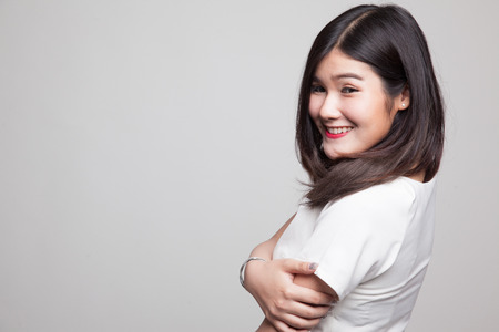 Happy Beautiful young Asian woman on gray backgroundの写真素材