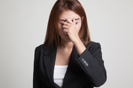 Young Asian woman got sick and  headache on gray backgroundの写真素材
