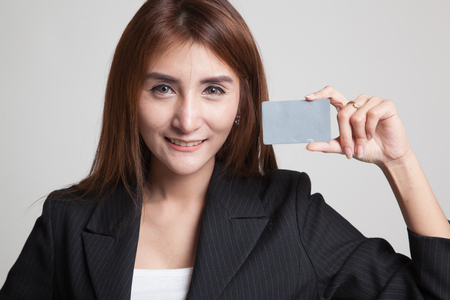 Young Asian woman smile with blank card on gray backgroundの写真素材