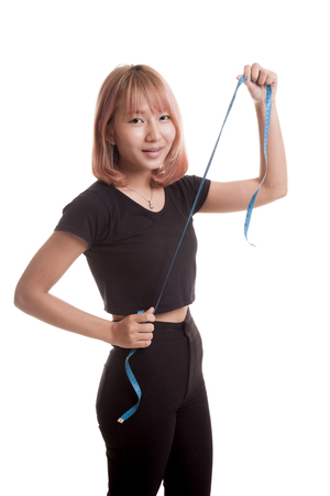 Young Asian woman with measuring tape isolated on white backgroundの写真素材