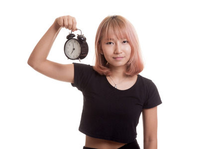 Young Asian woman with a clock isolated on white backgroundの写真素材