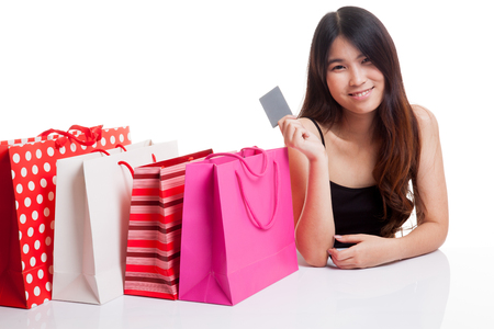 Young Asian woman with shopping bag and blank card isolated on white background isolated on white backgroundの写真素材