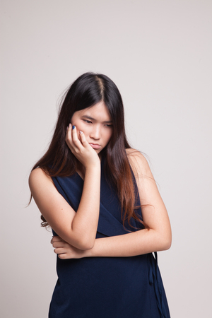 Beautiful young Asian woman get bored on gray backgroundの写真素材