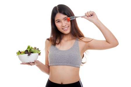 Beautiful Asian healthy girl enjoy eating  salad isolated on white backgroundの写真素材