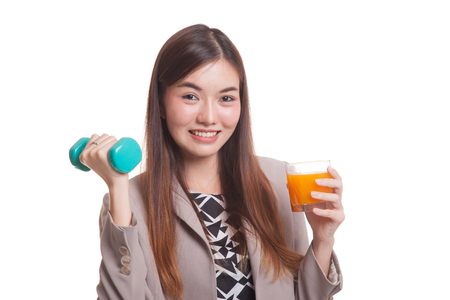 Young Asian woman with dumbbell drink orange juice isolated on white backgroundの写真素材