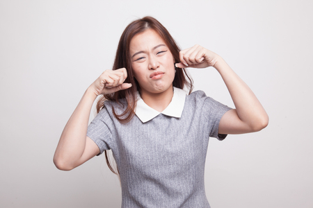 Young Asian woman sad and cry on gray backgroundの写真素材