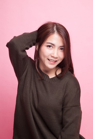 Beautiful young Asian woman on pink backgroundの写真素材