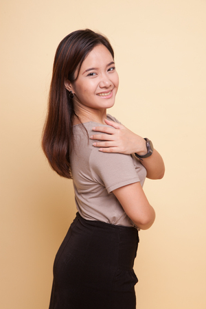 Happy Beautiful young Asian woman on beige backgroundの写真素材