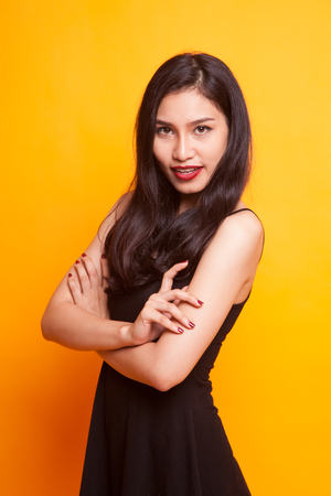 Portrait of beautiful young Asian woman on yellow backgroundの写真素材