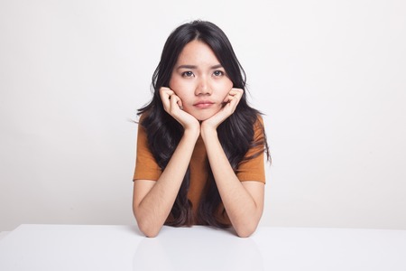 Asian girl with sad emotion on white backgroundの写真素材