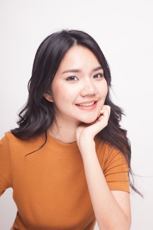 Portrait of beautiful young Asian woman on white background