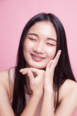 Portrait of beautiful young Asian woman on pink backgroundの写真素材