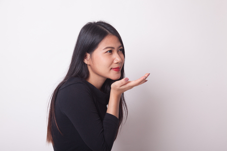Beautiful young Asian woman blow a kiss on white backgroundの写真素材
