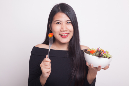 Healthy Asian woman with salad on white backgroundの写真素材