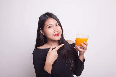 Young Asian woman point to orange juice on white backgroundの写真素材
