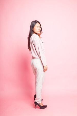 Beautiful young Asian woman in pink shirt on pink backgroundの写真素材