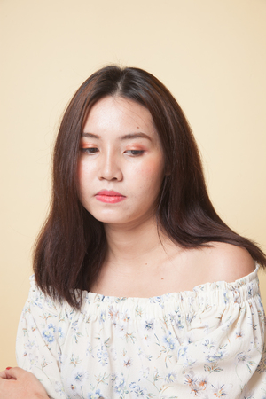 Portrait of beautiful young Asian woman on beige backgroundの写真素材