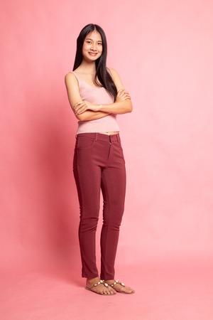 Full body of beautiful young asian woman on pink background