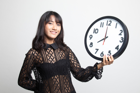 Young Asian woman with a clock on white background