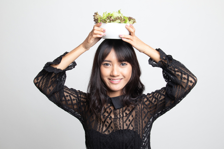 Healthy Asian woman with salad on white backgroundの写真素材