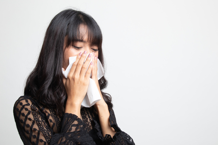 Young Asian woman got sick and flu on white backgroundの写真素材