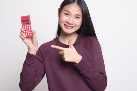 Asian woman point to  calculator on white backgroundの写真素材