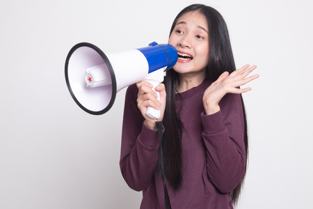 Beautiful young Asian woman announce with megaphone on white backgroundの写真素材