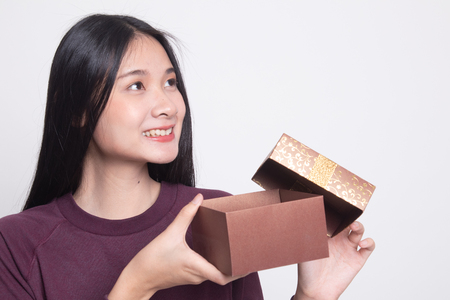 Young Asian woman open a gift box on white backgroundの写真素材