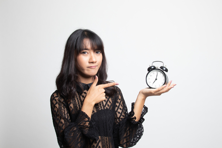 Angry young Asian woman point to a clock on white backgroundの写真素材