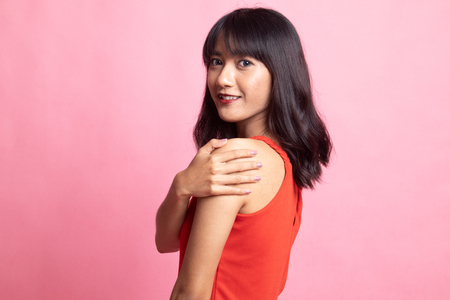 Happy Beautiful young Asian woman on pink backgroundの写真素材