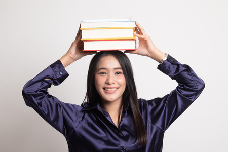 Young Asian woman studying  with may books on white backgroundの写真素材