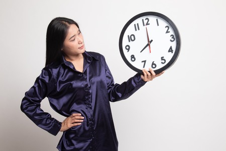 Young Asian woman with a clock on white background