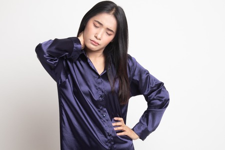 Young Asian woman got neck pain on white backgroundの写真素材