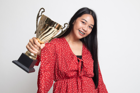 Successful young asian woman holding a trophy on white backgroundの写真素材