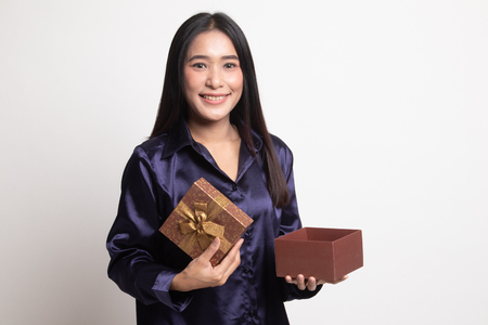 Young Asian woman open a golden gift box on white backgroundの写真素材