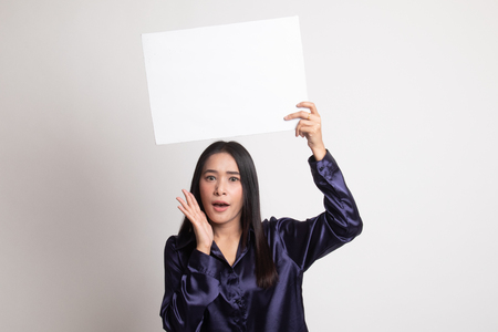 Young Asian woman surprise with white blank sign on white backgroundの写真素材
