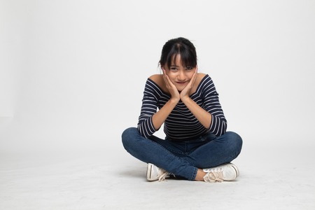 Full body of  beautiful young Asian woman  sit on floor  on white background