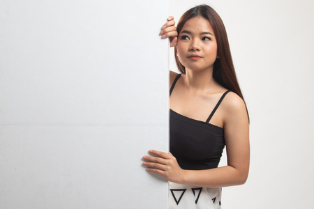 Young Asian woman with blank sign on white backgroundの写真素材