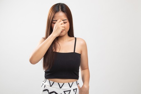 Young Asian woman got sick and  headache on white backgroundの写真素材