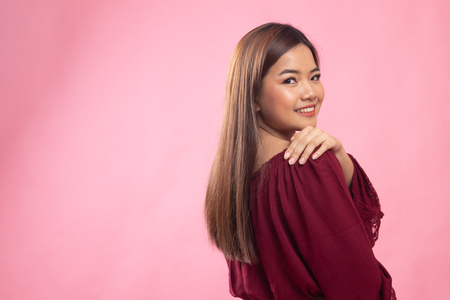 Happy Beautiful young Asian woman on pink backgroundの写真素材