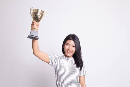 Successful young asian woman holding a trophy on white backgroundの写真素材