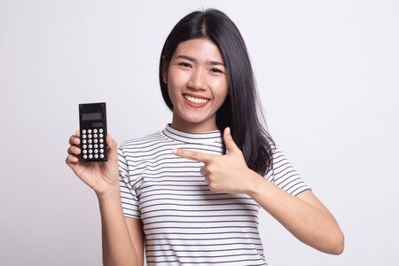Asian woman point to  calculator on white backgroundの写真素材