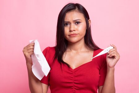 Young Asian woman got sick and flu on pink backgroundの写真素材