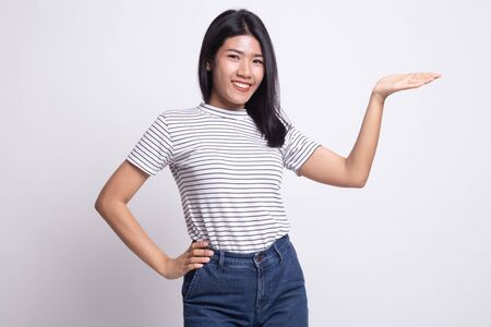 Young Asian woman present with her hand on white backgroundの写真素材