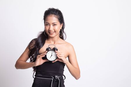 Young Asian woman smile with a clock on white backgroundの写真素材